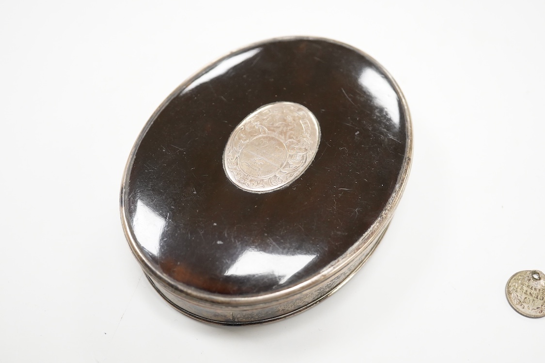 A 19th century white metal mounted tortoiseshell oval snuff box, with inset oval white metal plaque engraved with family crest, unmarked, 10.1cm.